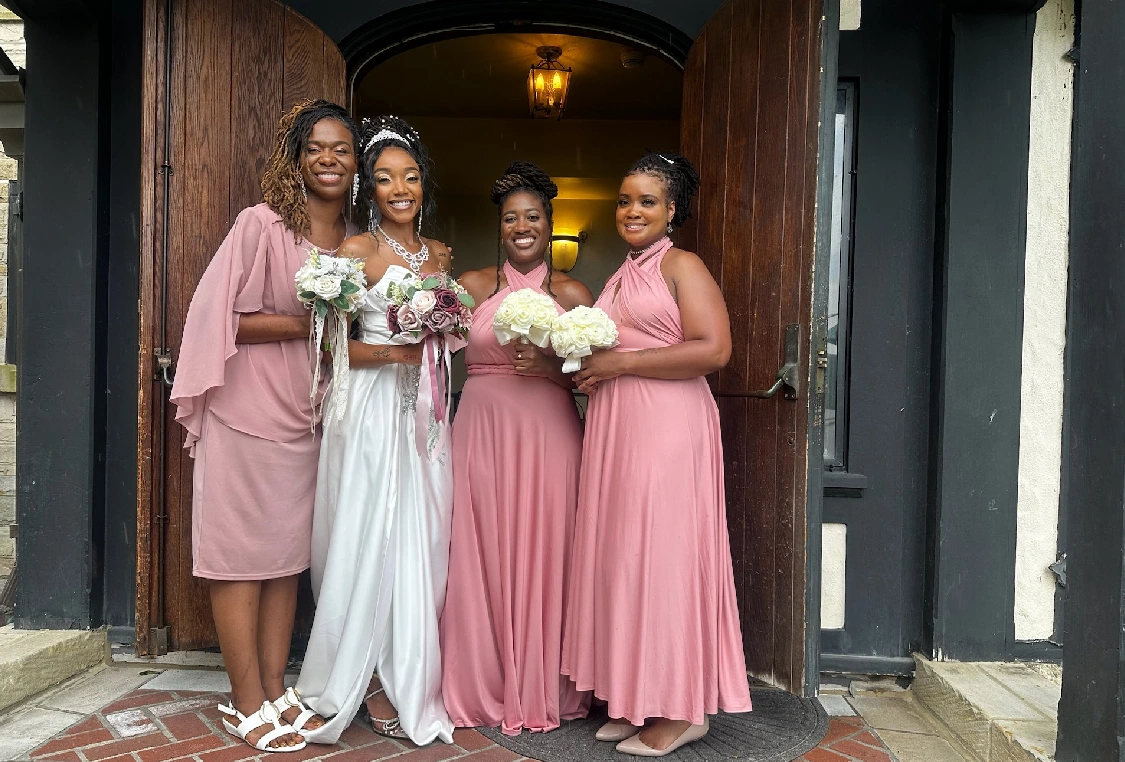 A group of women standing in front of a door.