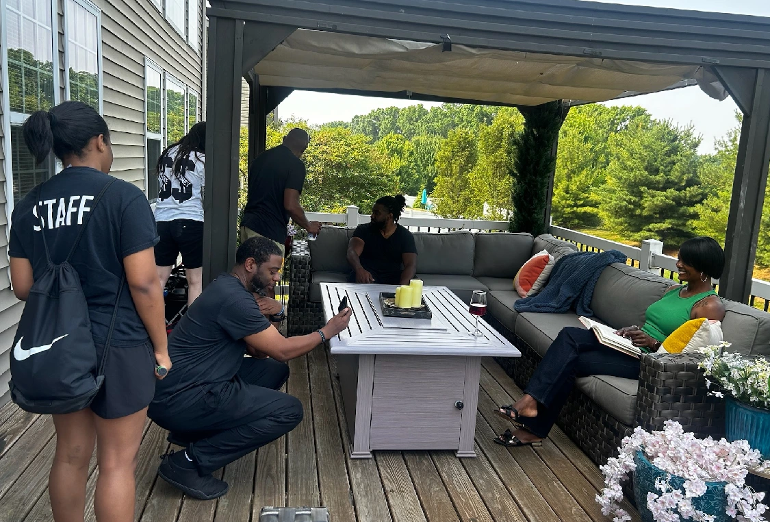 A group of people gathered around an outdoor table.